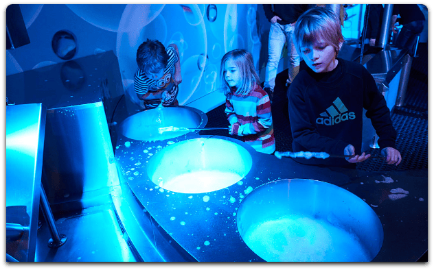 Photograph of children exploring the exhibits in the community science museum