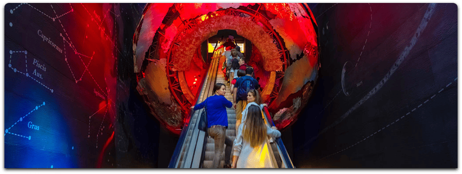 People visiting the community science museum, using escalator to enter